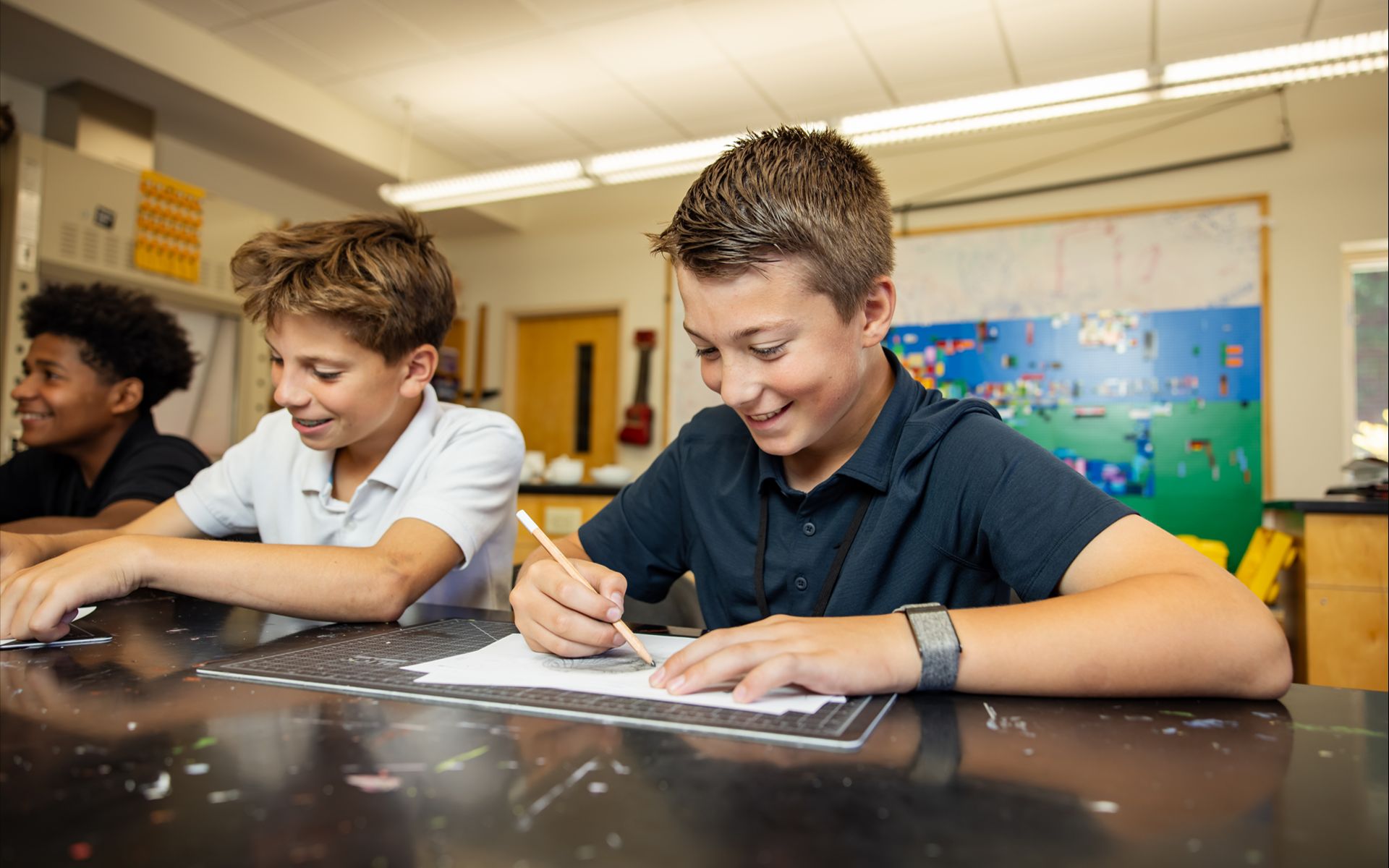 Students tracing with pencil