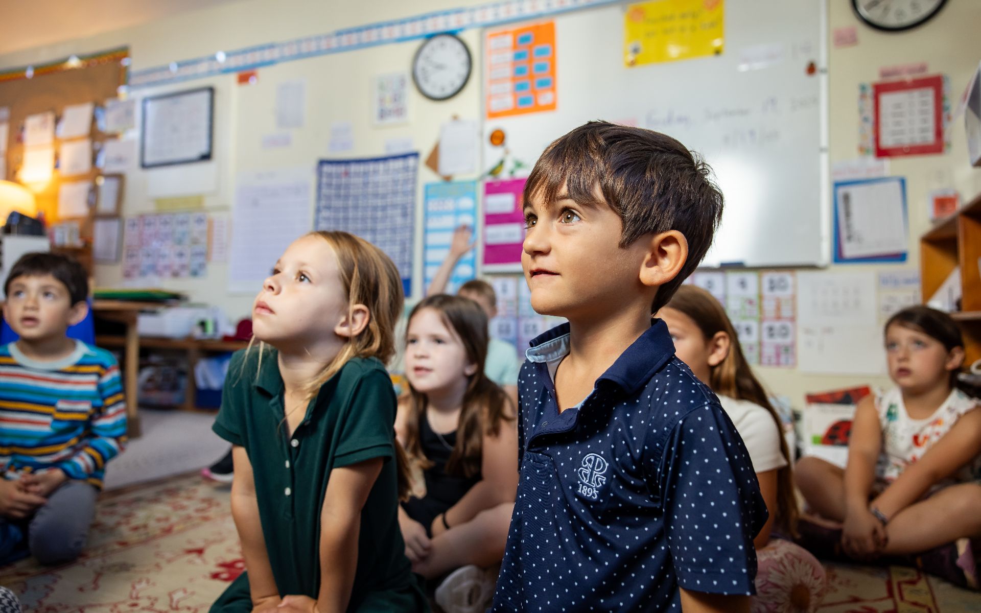Young students listening attentively in a primary school classroom