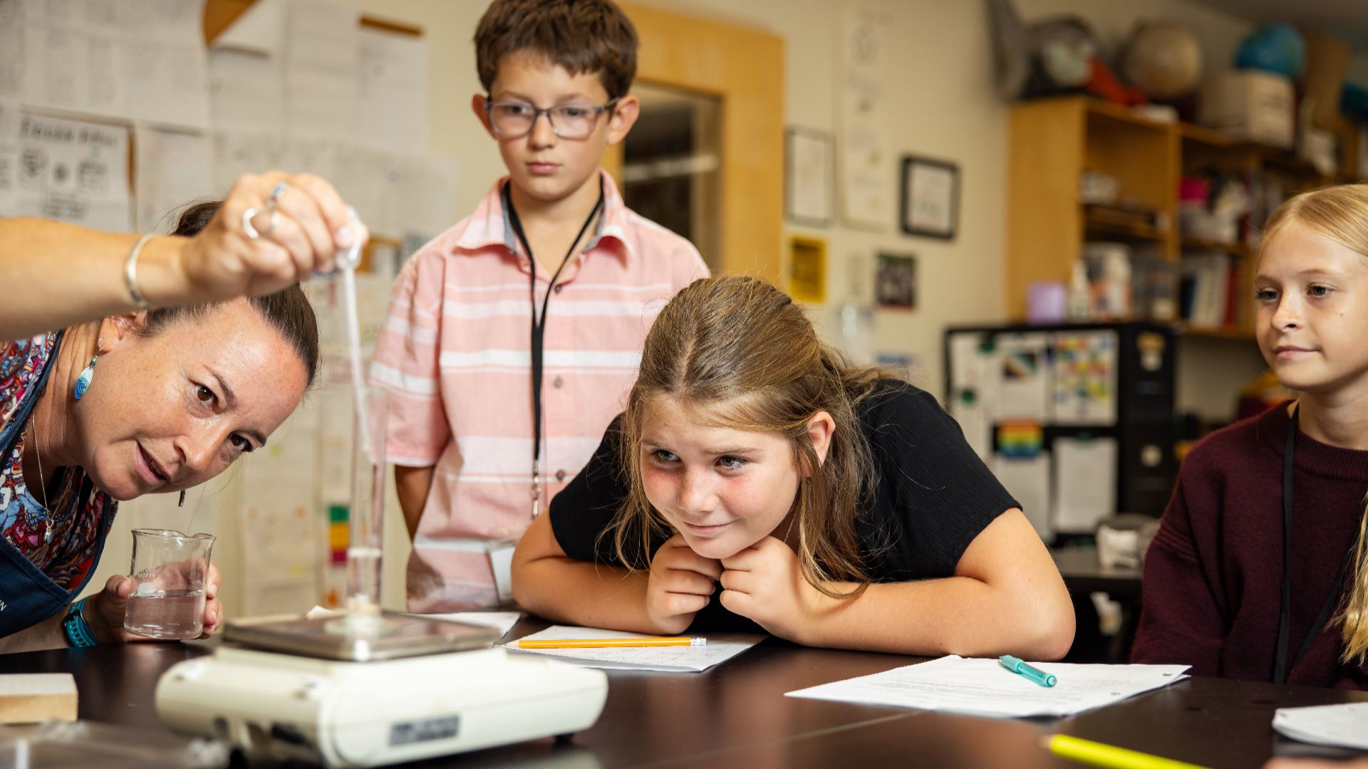 Teacher and students conducting a science experiment